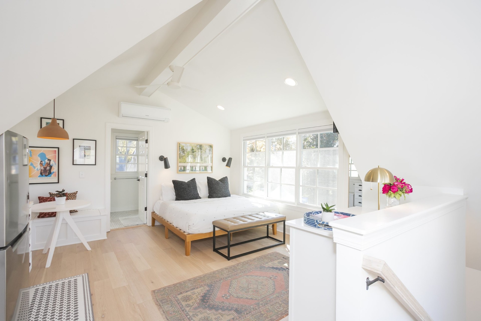 Studio interior of an above-garage apartment with bed and dining area — a Nashville short-term rental managed by Rest Easy Nashville